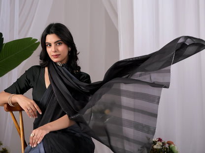Premium Monsoon Saree featuring a classy Silk blend of deep black and smoky grey tones with a silky smooth flow, designed to deliver a bold, elegant, and timeless look.