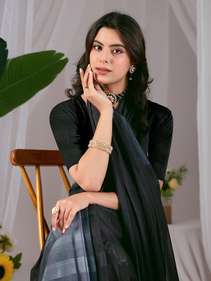 Premium Monsoon Saree featuring a classy Silk blend of deep black and smoky grey tones with a silky smooth flow, designed to deliver a bold, elegant, and timeless look.